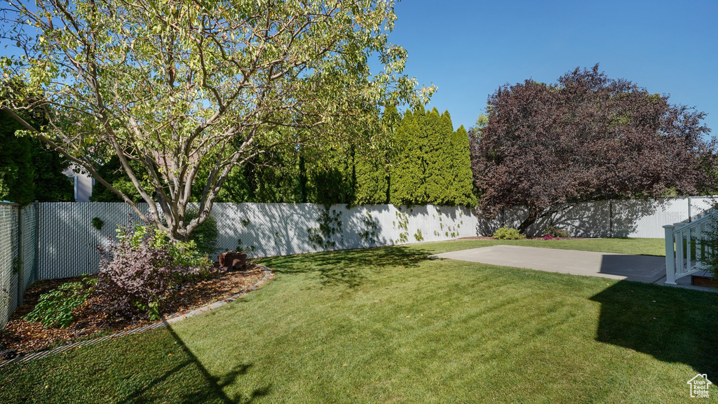 View of yard featuring a fenced backyard and a patio area