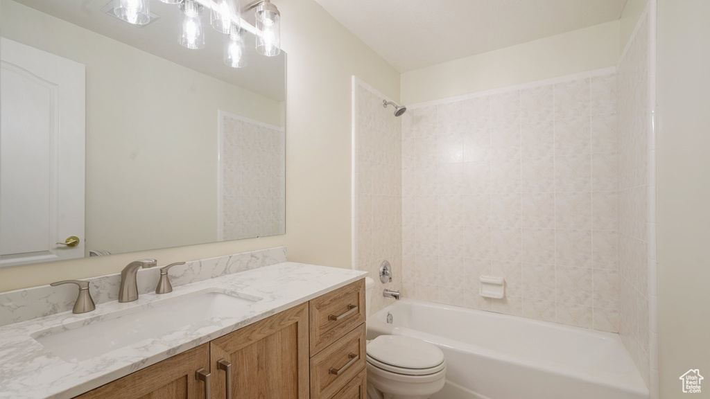 Full bath with toilet, bathing tub / shower combination, and vanity