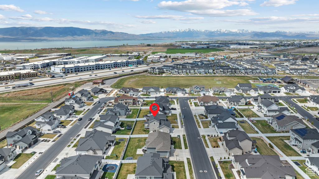 Birds eye view of property featuring a water and mountain view