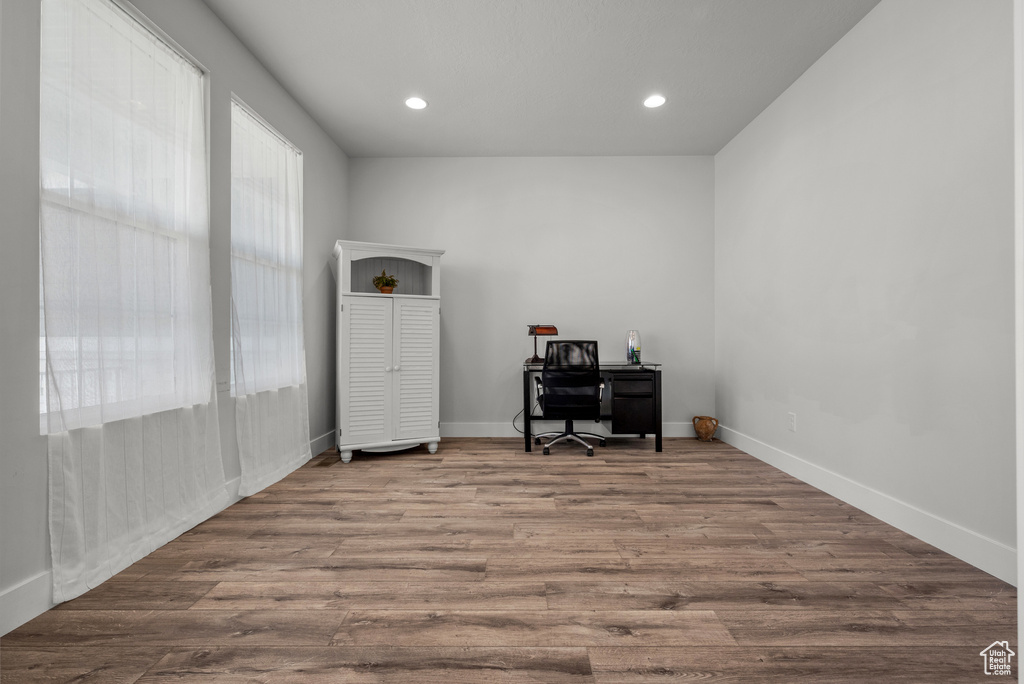 Home office featuring recessed lighting, baseboards, and wood finished floors