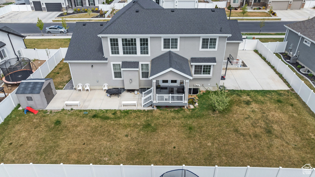 Back of house with a fenced backyard, a patio area, and stucco siding