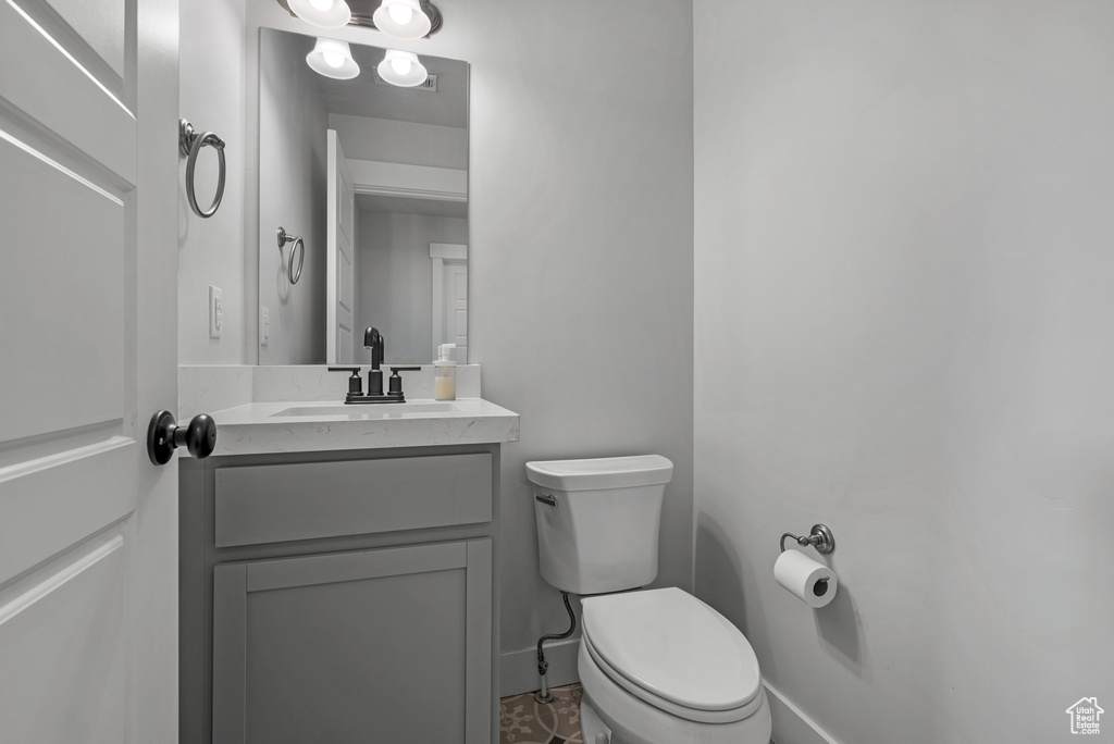 Half bath featuring vanity and toilet