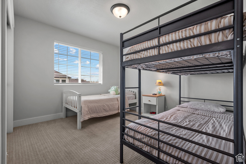 Bedroom with baseboards and carpet