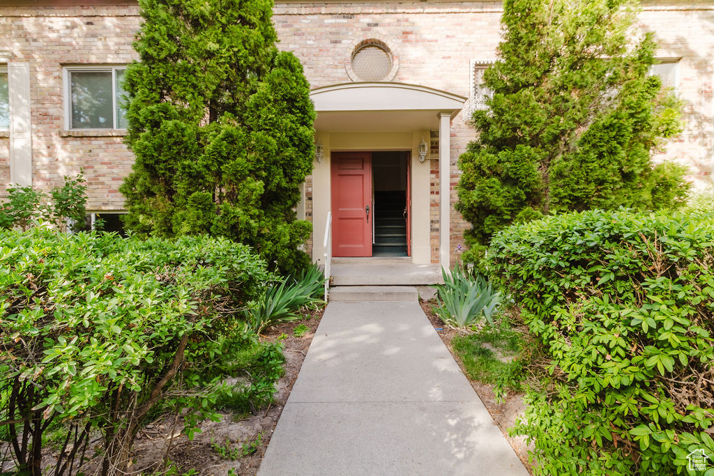 View of exterior entry featuring brick siding