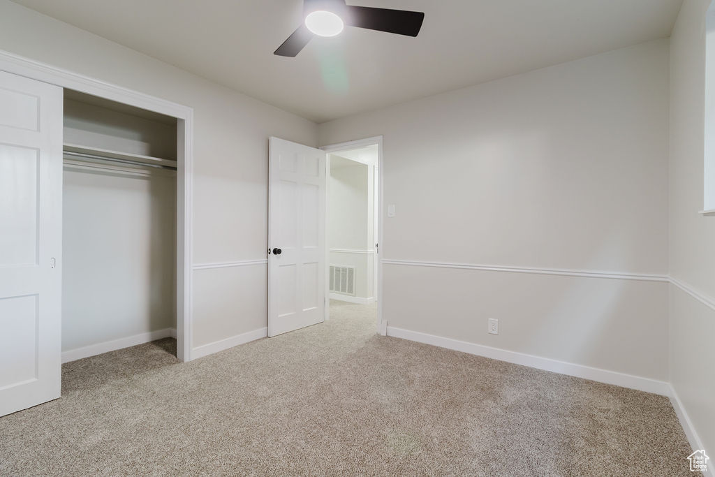 Unfurnished bedroom featuring baseboards, a closet, visible vents, and carpet
