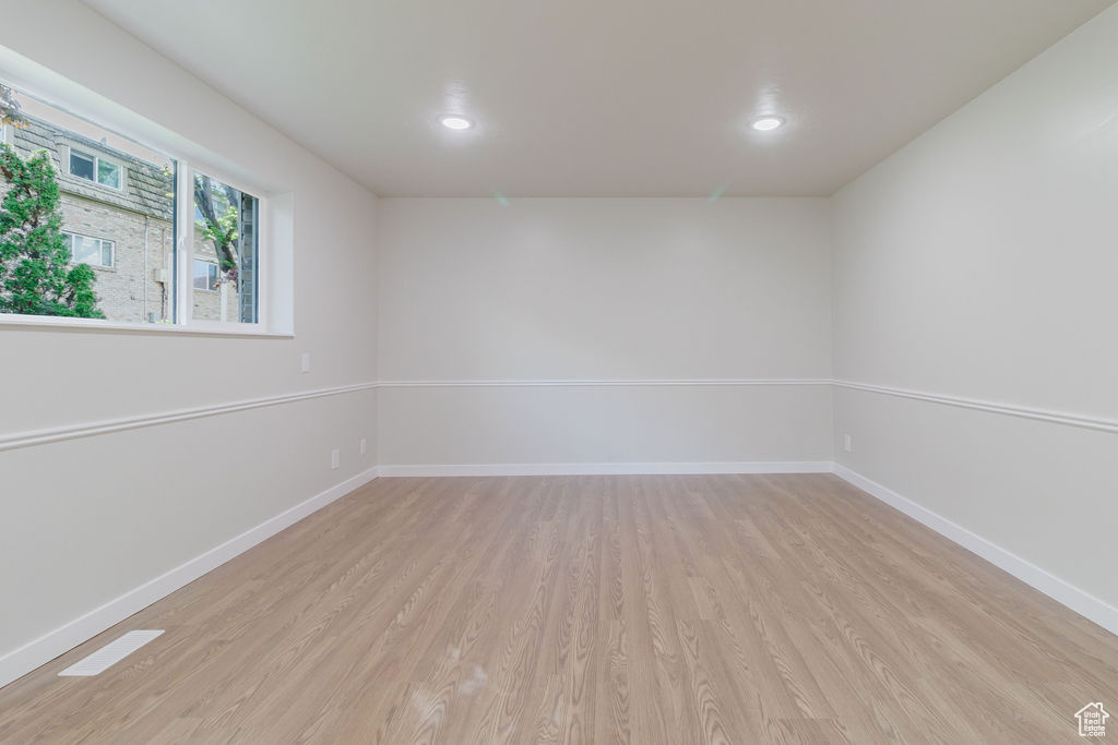 Spare room featuring light wood-style flooring, baseboards, and recessed lighting