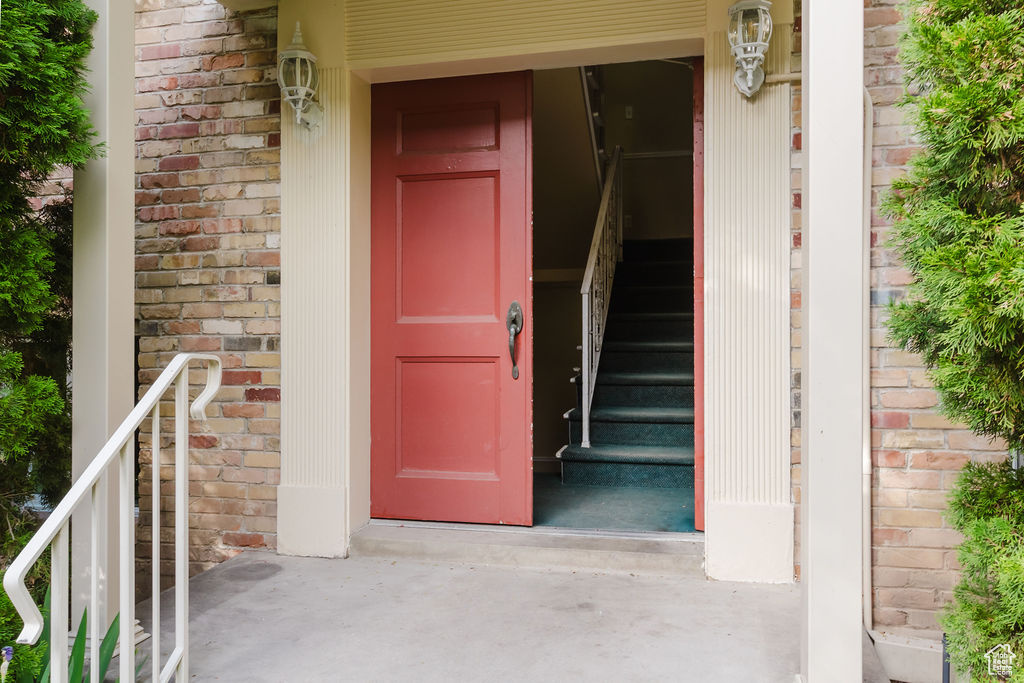 Entrance to property featuring brick siding