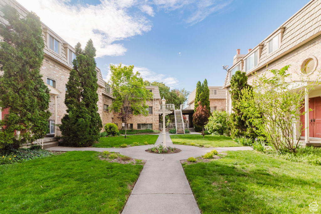 View of property's community with a yard