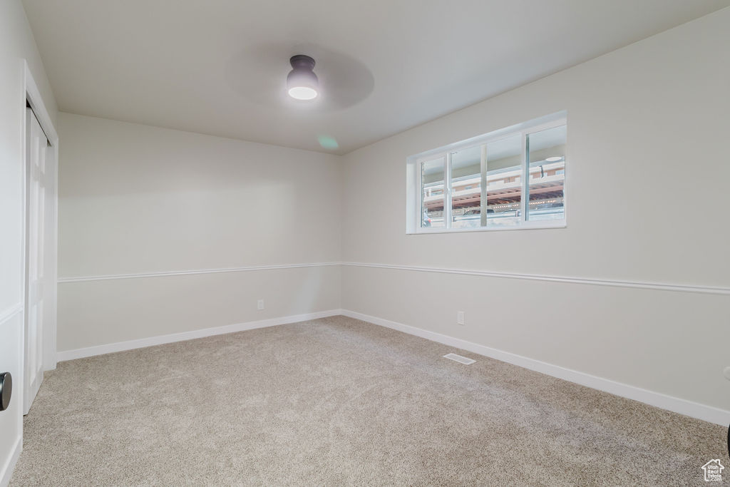 Unfurnished room with ceiling fan, carpet flooring, and baseboards