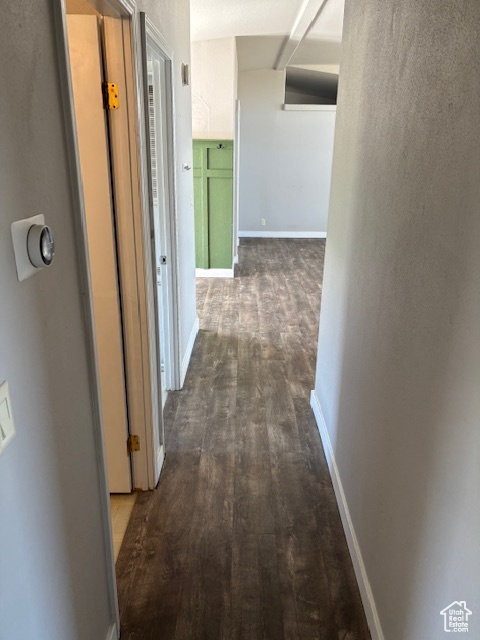 Hallway featuring baseboards and wood finished floors