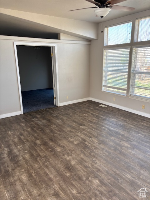 Unfurnished bedroom featuring baseboards, a ceiling fan, wood finished floors, and lofted ceiling