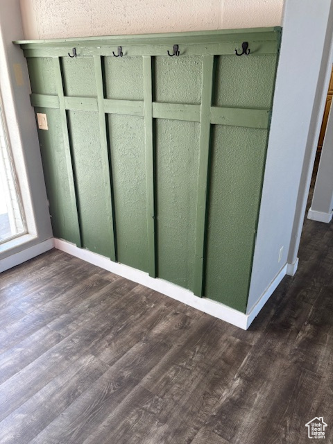 Interior space with baseboards and wood finished floors