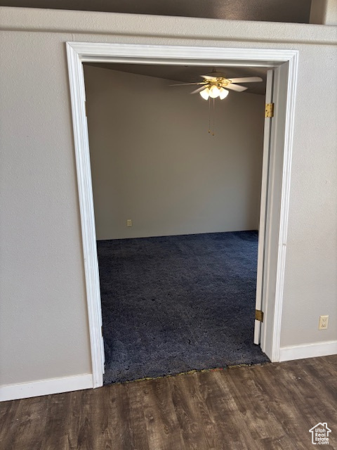 Interior space featuring baseboards, carpet, and wood finished floors