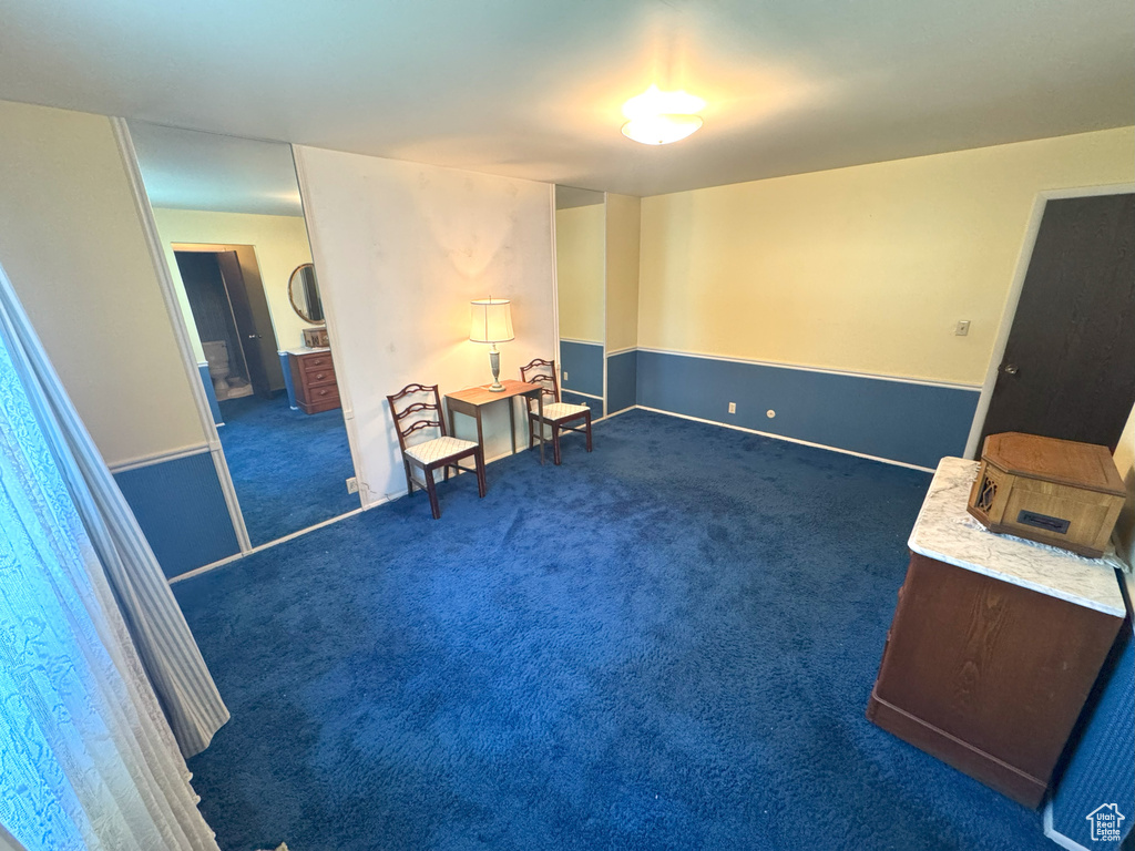 Sitting room with baseboards and carpet