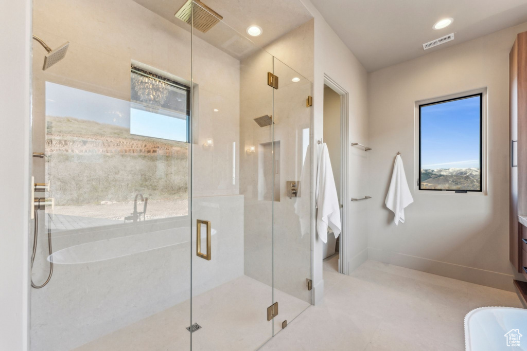 Full bathroom with a shower stall, baseboards, and visible vents