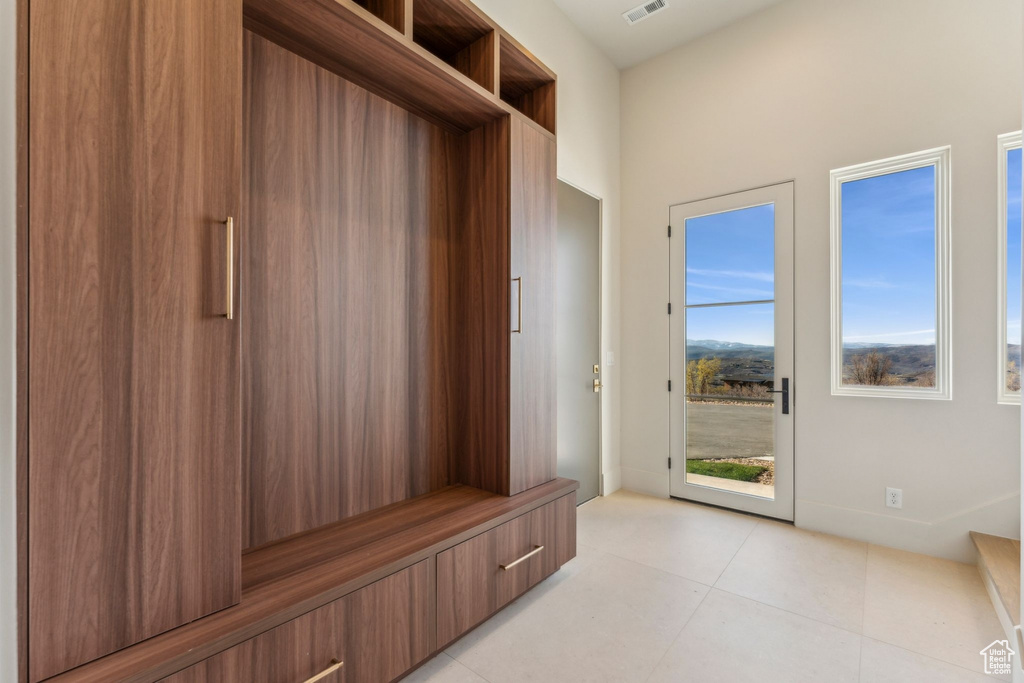Mudroom featuring light tile patterned floors and visible vents
