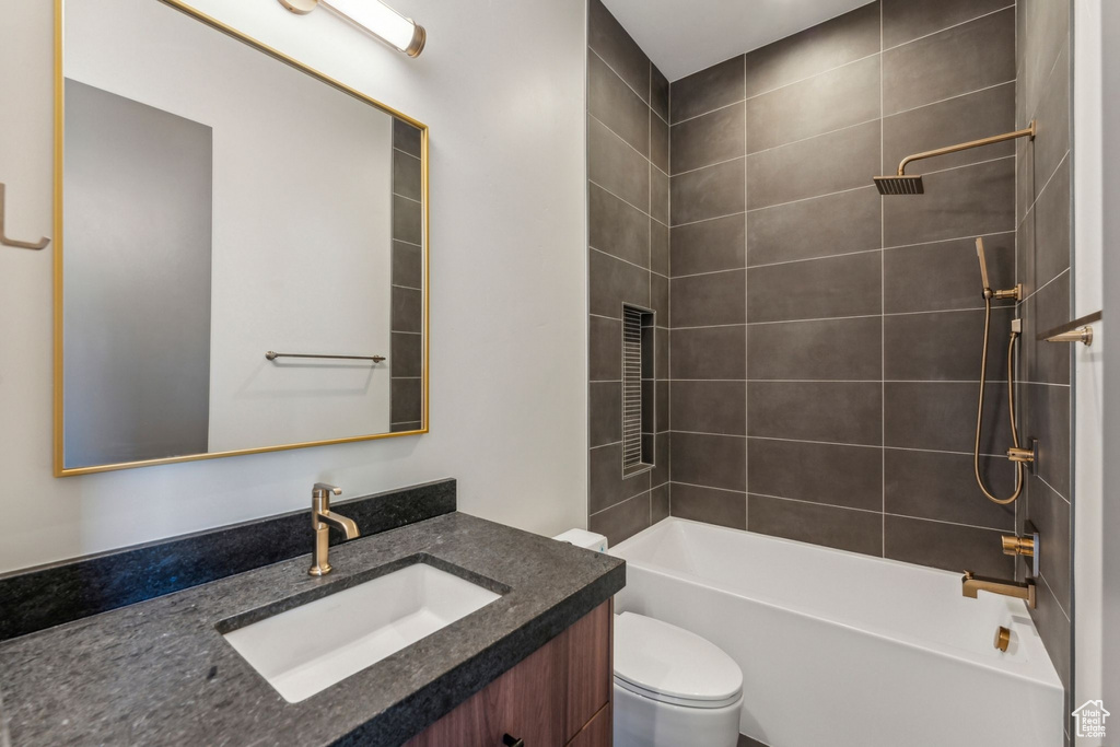Full bathroom featuring toilet, shower / bathtub combination, and vanity