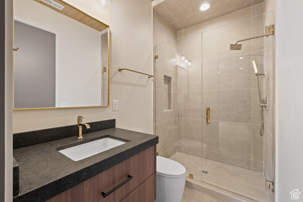 Bathroom with toilet, a stall shower, visible vents, vanity, and recessed lighting