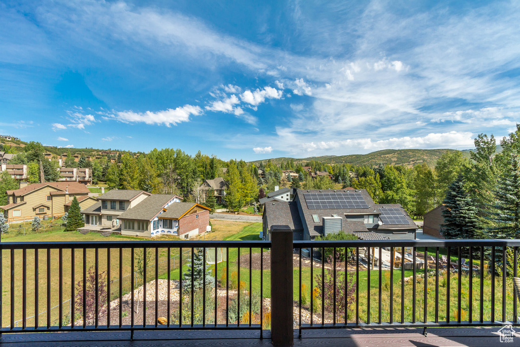 Wooden deck with a residential view and a mountain view