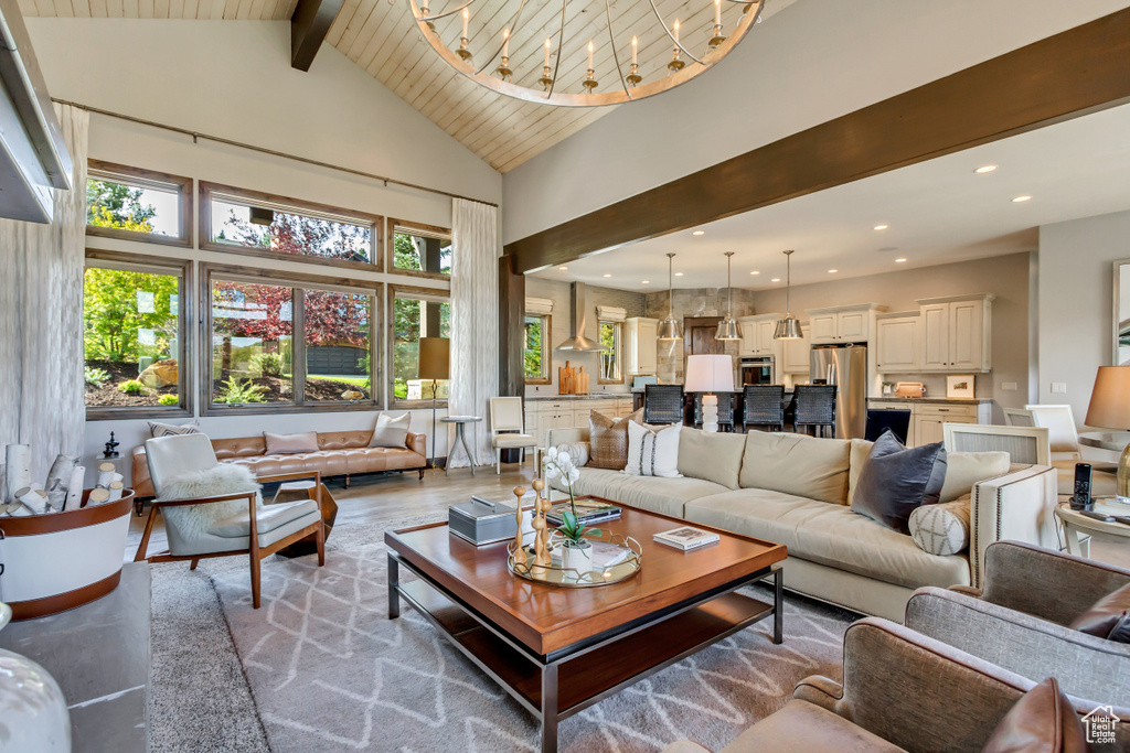 Living area featuring recessed lighting, wood finished floors, high vaulted ceiling, and beamed ceiling