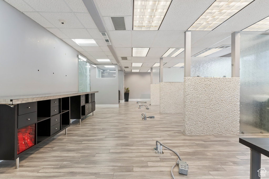 Interior space featuring baseboards, light wood finished floors, and visible vents