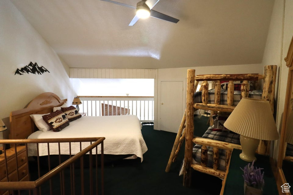 Bedroom featuring vaulted ceiling and carpet