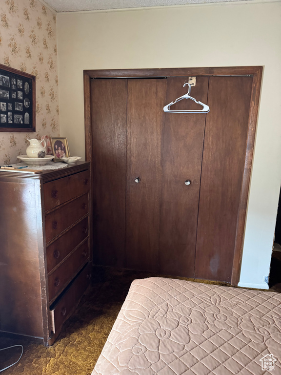 Bedroom featuring wallpapered walls
