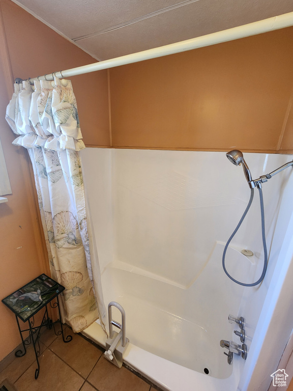Bathroom featuring tile patterned flooring and shower / bath combo