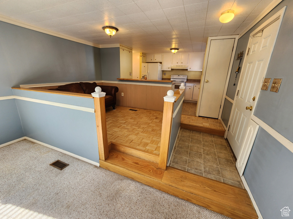 Interior space with carpet floors, baseboards, and visible vents