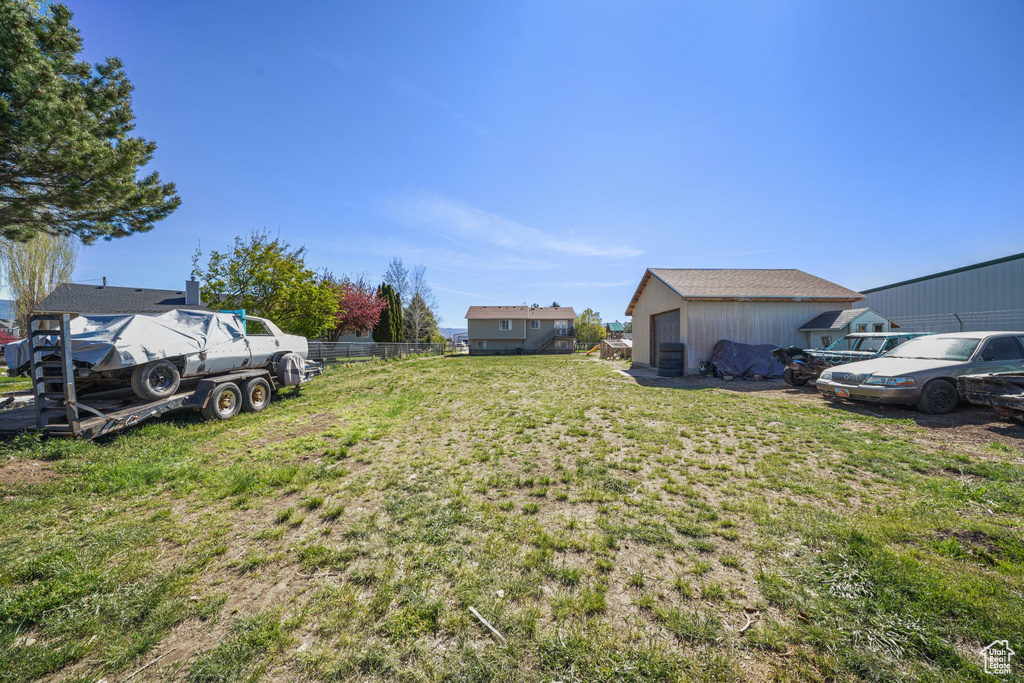 View of yard with fence and a detached garage