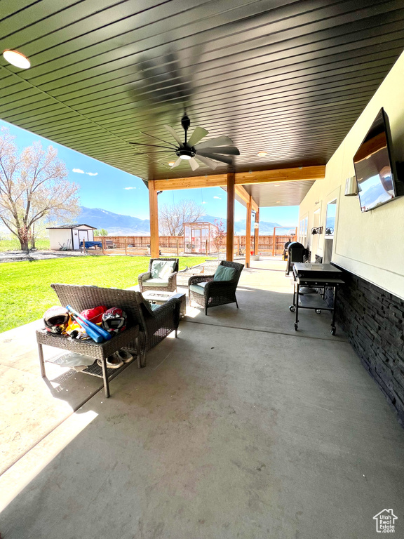 View of patio / terrace with a ceiling fan, an outdoor living space, and a fenced backyard