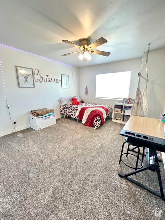 Carpeted bedroom with baseboards and ceiling fan