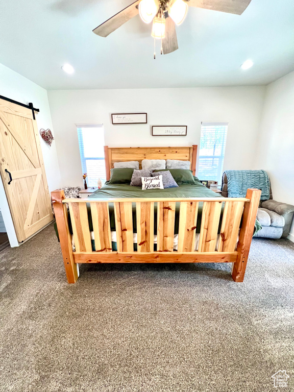 Carpeted bedroom featuring recessed lighting and a barn door
