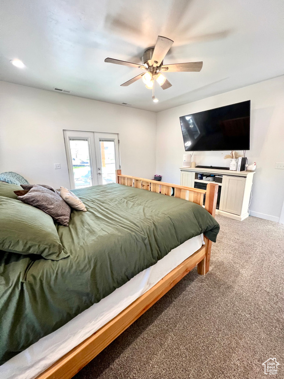 Bedroom featuring french doors, access to exterior, baseboards, ceiling fan, and light colored carpet
