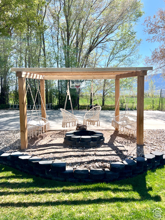 View of community featuring a patio area and a fire pit
