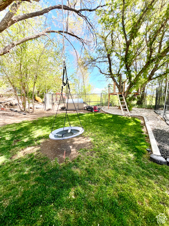 View of yard with a playground and fence private yard