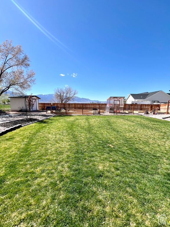 View of yard featuring an outbuilding and a fenced backyard