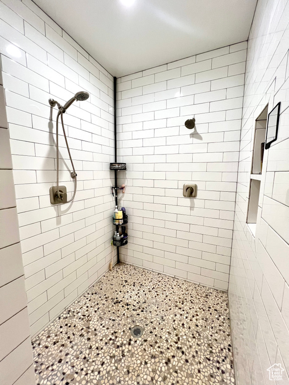 Full bath featuring tiled shower