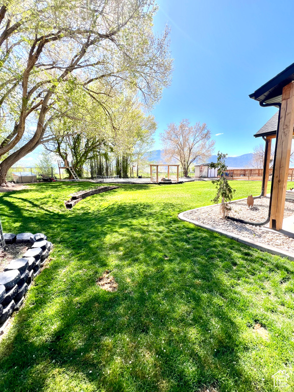 View of yard with a mountain view and fence private yard