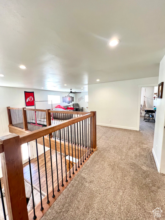 Hall featuring carpet, baseboards, an upstairs landing, and recessed lighting