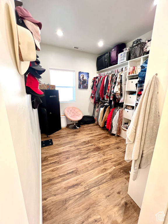 Spacious closet featuring visible vents and wood finished floors