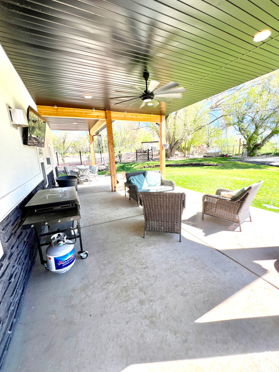 View of patio / terrace with a fenced backyard, area for grilling, outdoor lounge area, and a ceiling fan