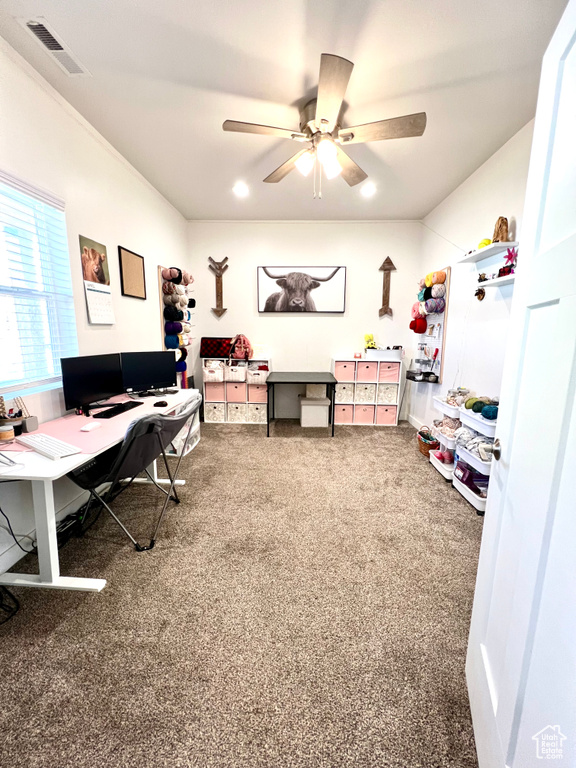 Carpeted office space featuring a ceiling fan and visible vents
