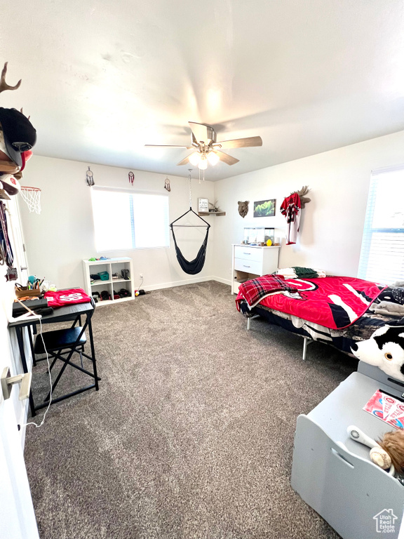 Bedroom with ceiling fan, carpet, and baseboards