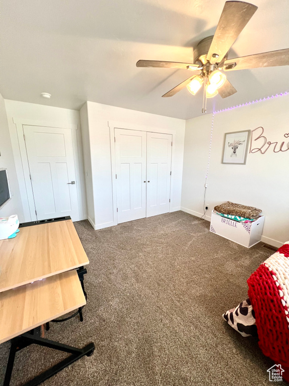 Bedroom with baseboards, a ceiling fan, and carpet floors