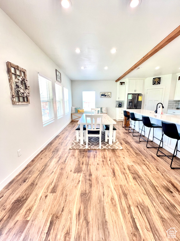 Living area featuring light wood finished floors, baseboards, and recessed lighting