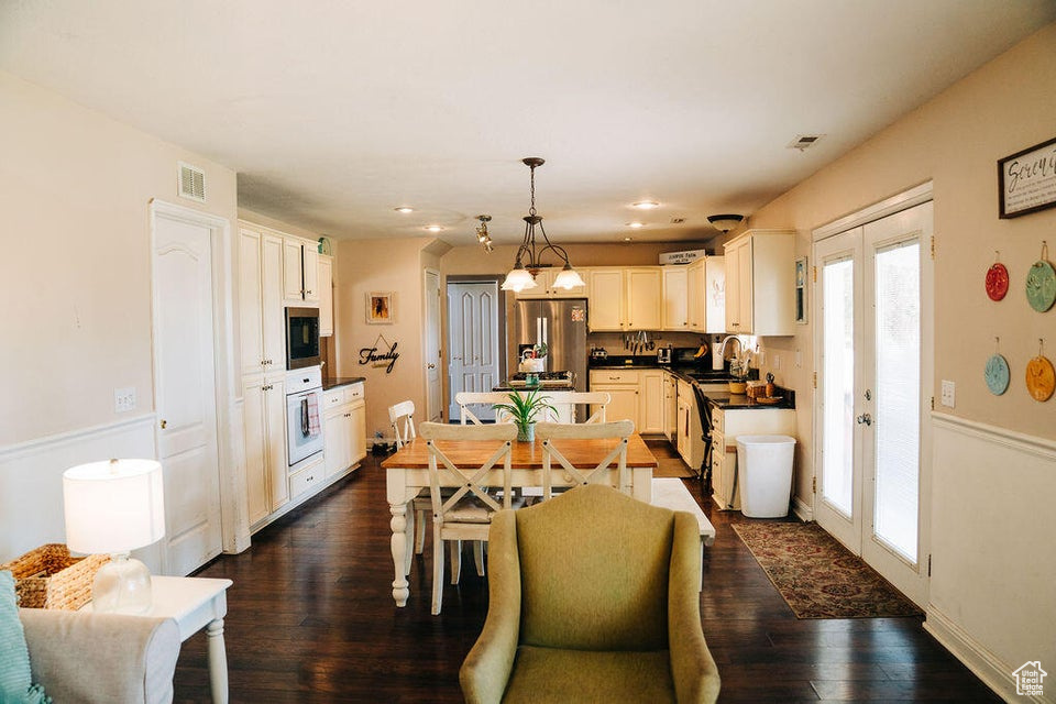 Dining room with recessed lighting, visible vents, and dark wood-type flooring