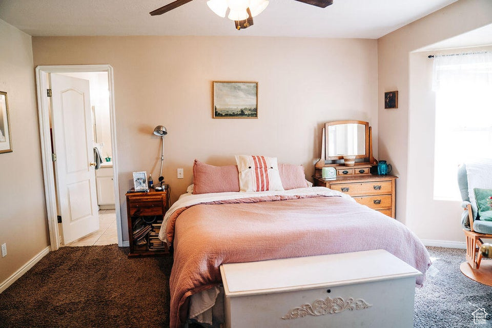Bedroom with baseboards, multiple windows, carpet flooring, and ceiling fan
