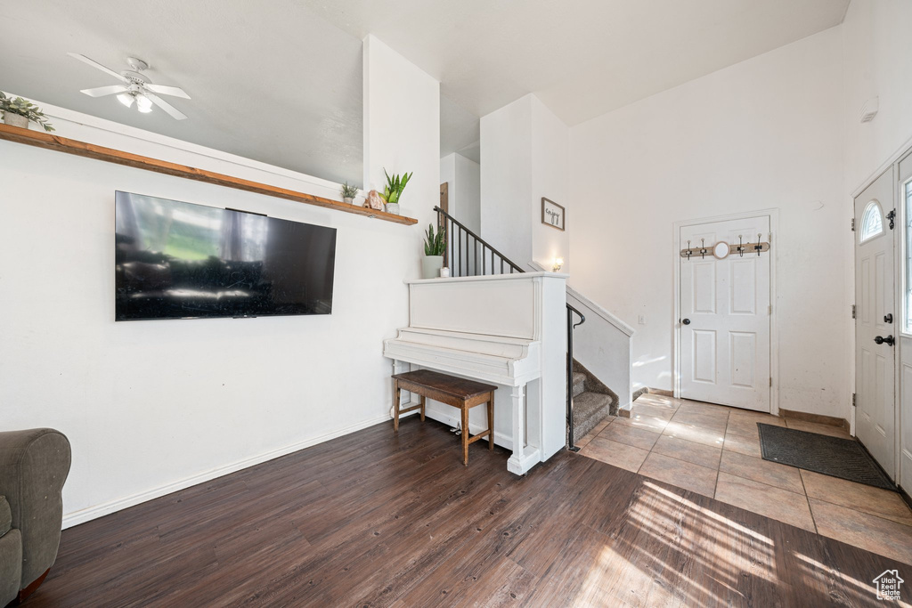 Entryway with baseboards, stairs, ceiling fan, and wood finished floors