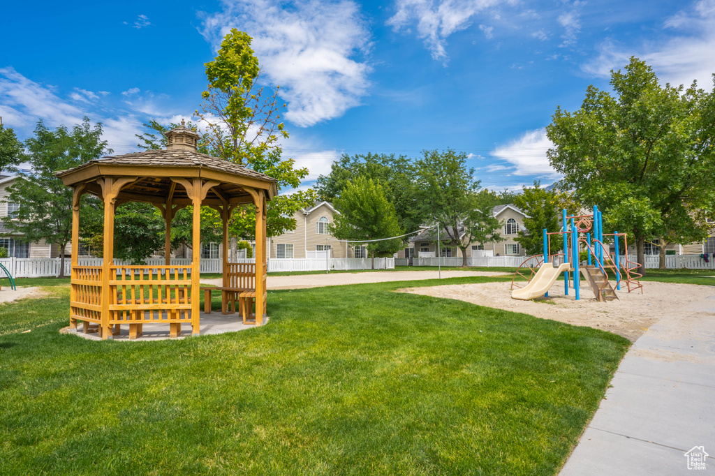 Community jungle gym featuring a yard, a gazebo, and fence